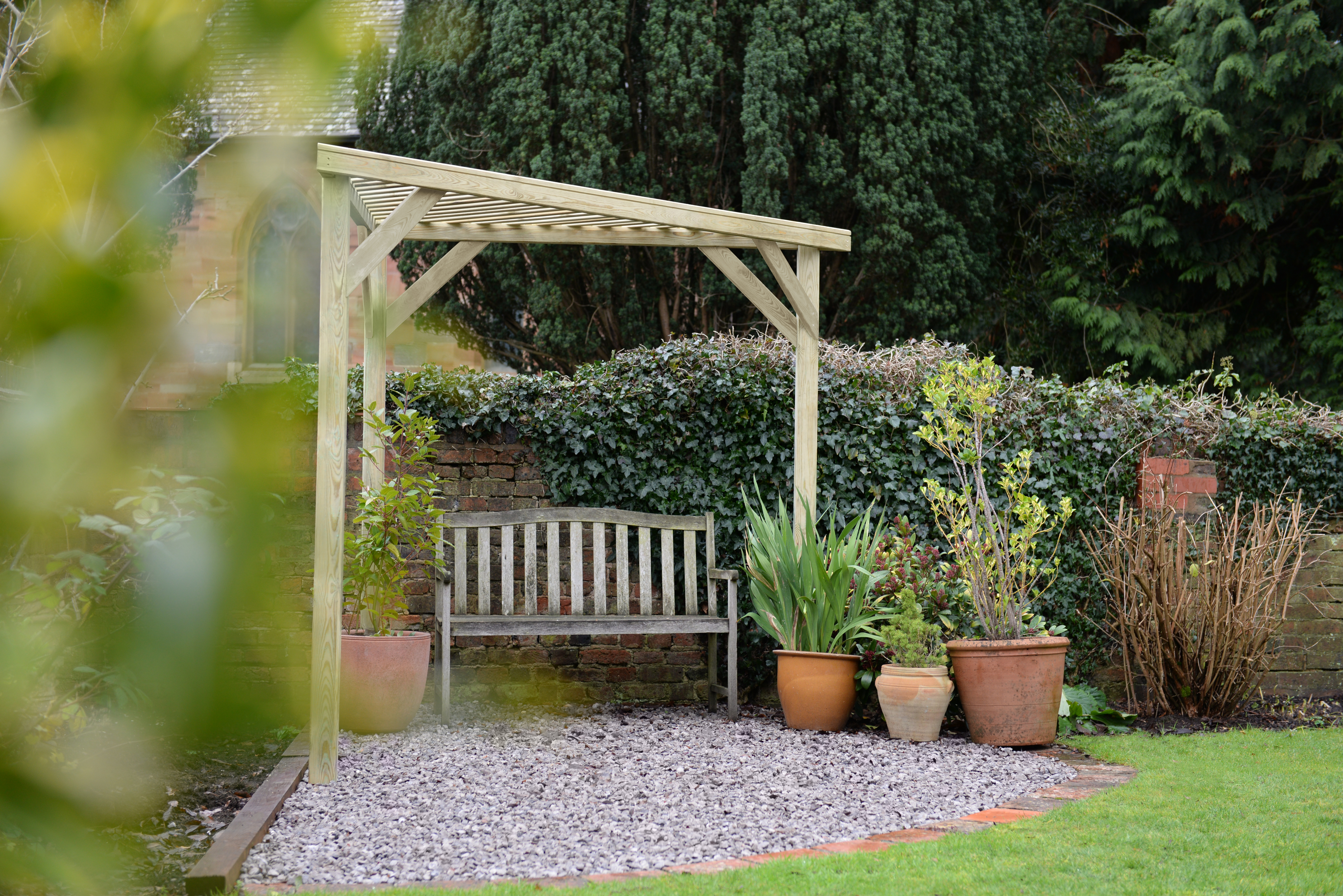 Slatted corner pergola by forest garden